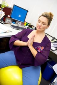 Using fitness balls instead of chairs while working comes with a lot of pros and cons (Image via Free Images/Banana Stock)